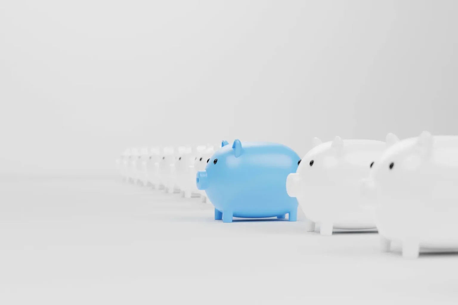 Picture of a line of piggy banks with one blue piggy bank